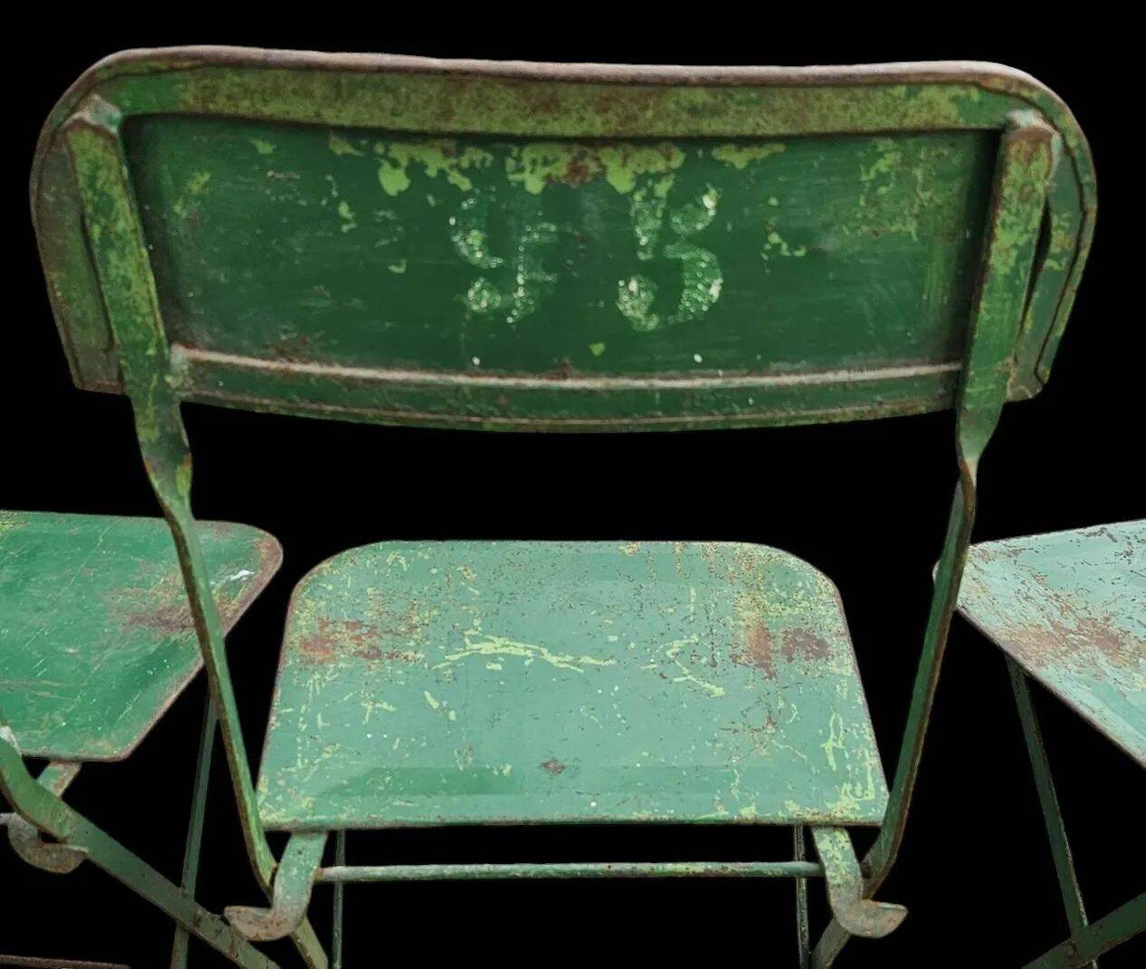 Set of 8 green painted metal industrial folding chairs.