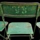 Set of 8 green painted metal industrial folding chairs.