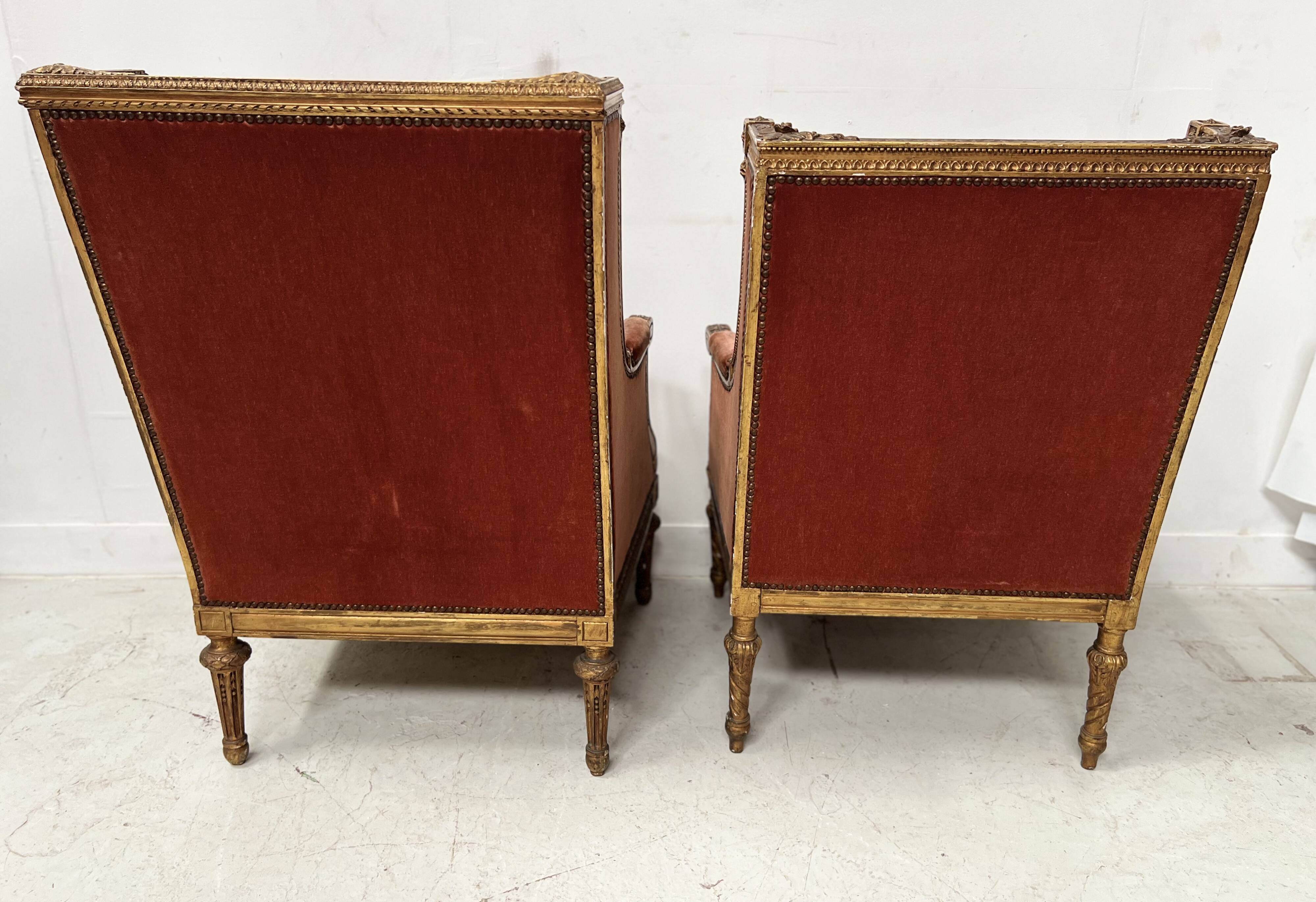 Two Louis XVI style wing chairs in gilded wood, 20th century