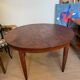 Oval extendable dining table in wood and walnut burl veneer.
