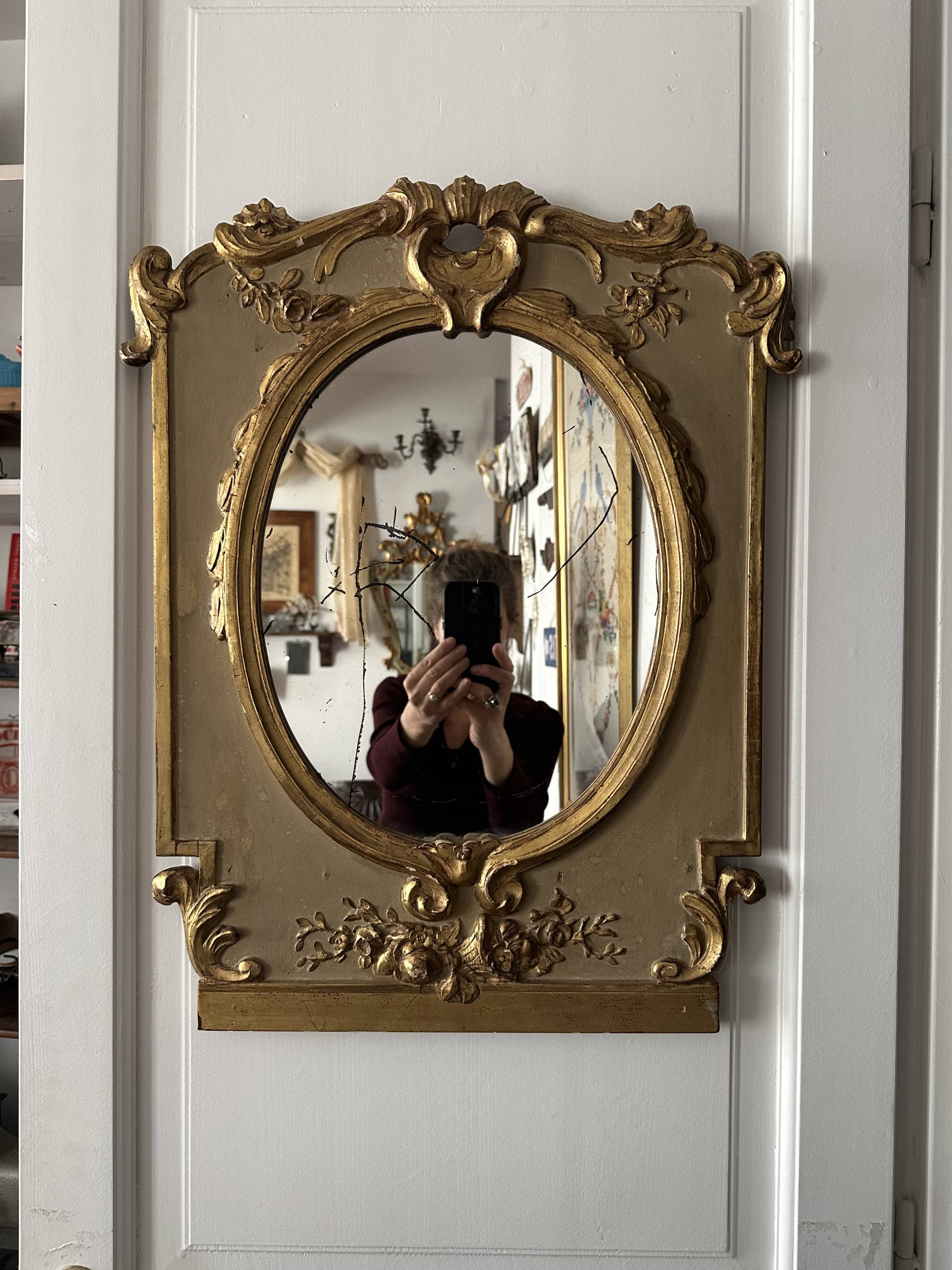 Napoleon III mirror in carved gilded wood, oval mercury glass.