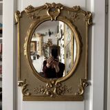 Napoleon III mirror in carved gilded wood, oval mercury glass.