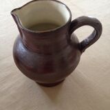 Pitcher has water in glazed stoneware of dark brown color
