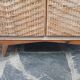 Vintage woven rattan furniture with tapered legs.