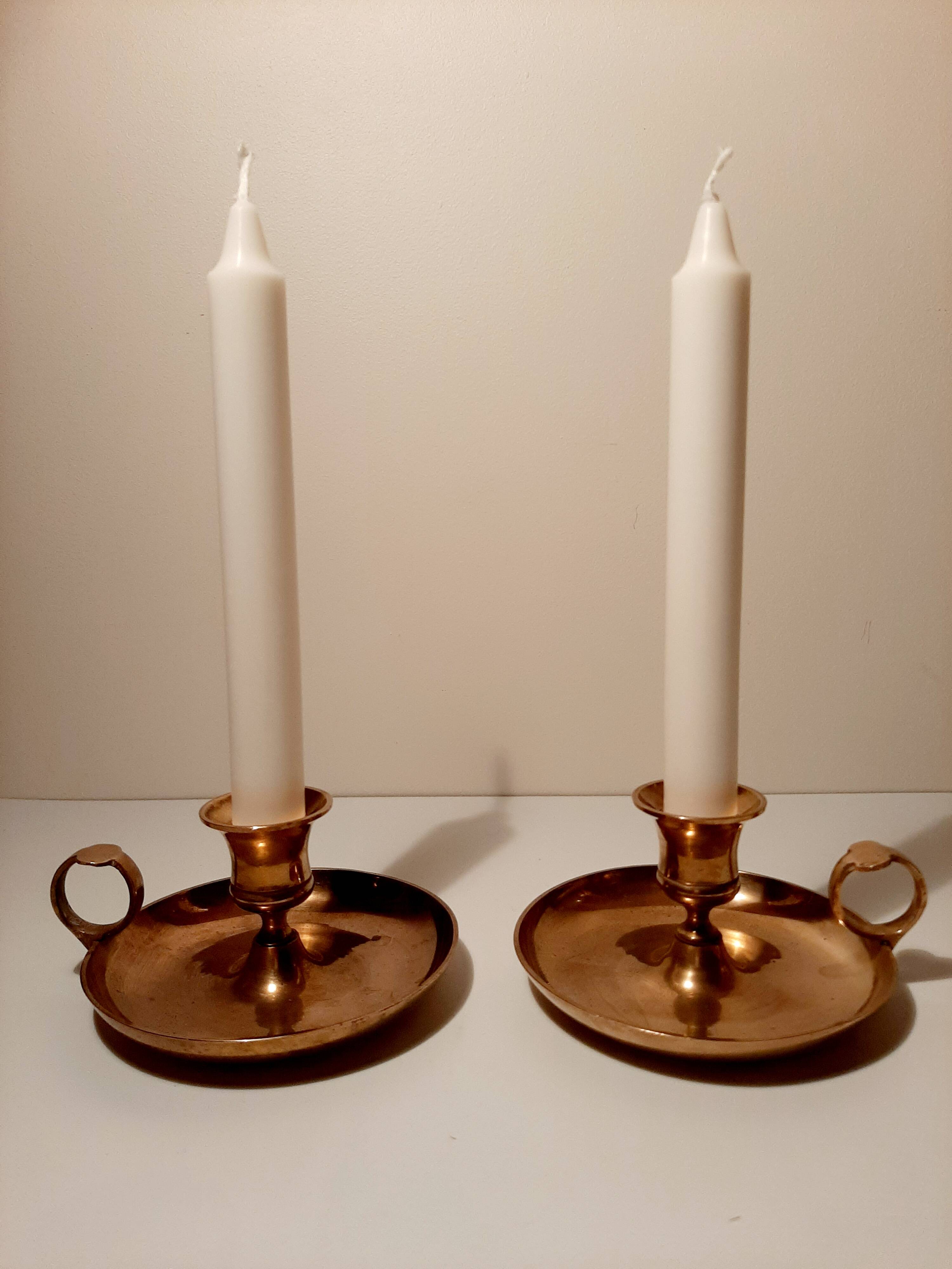 Pair of brass hand candlesticks