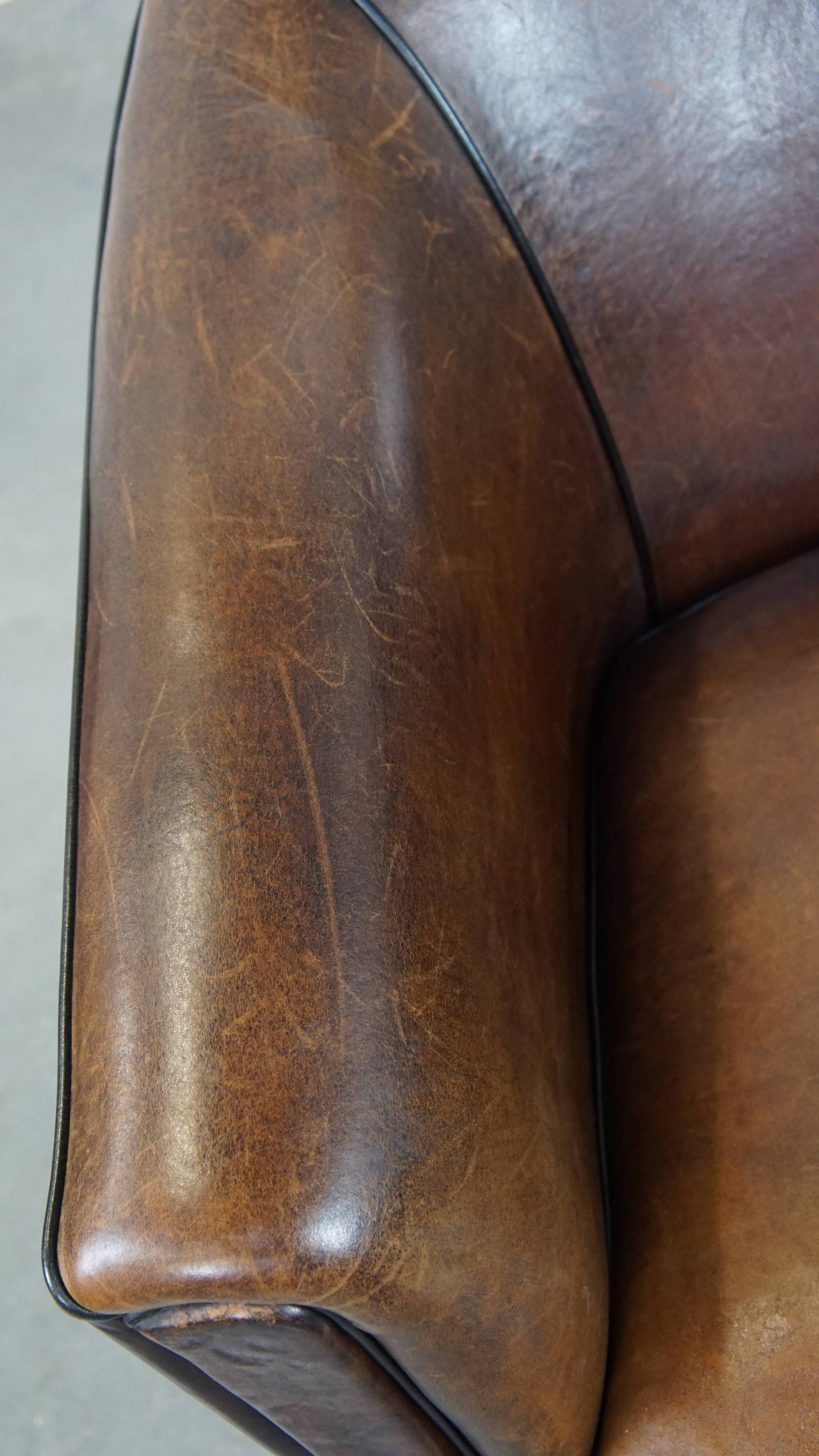 Sheep leather club chair finished with black piping