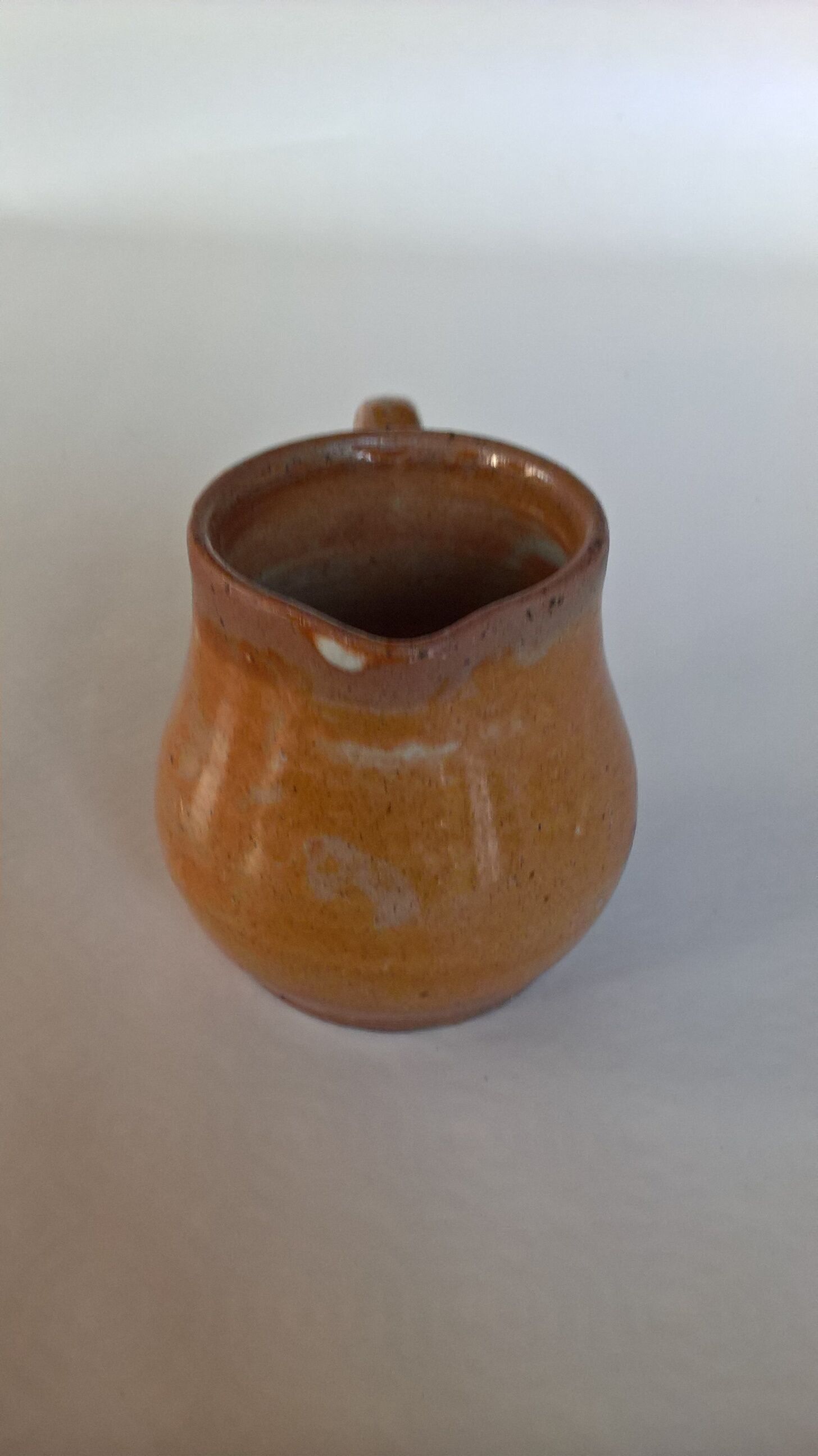 Creamy milk pot in sandstone