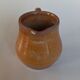 Creamy milk pot in sandstone