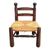 Low chair in turned wood and straw