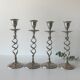 Four twisted silver candlesticks