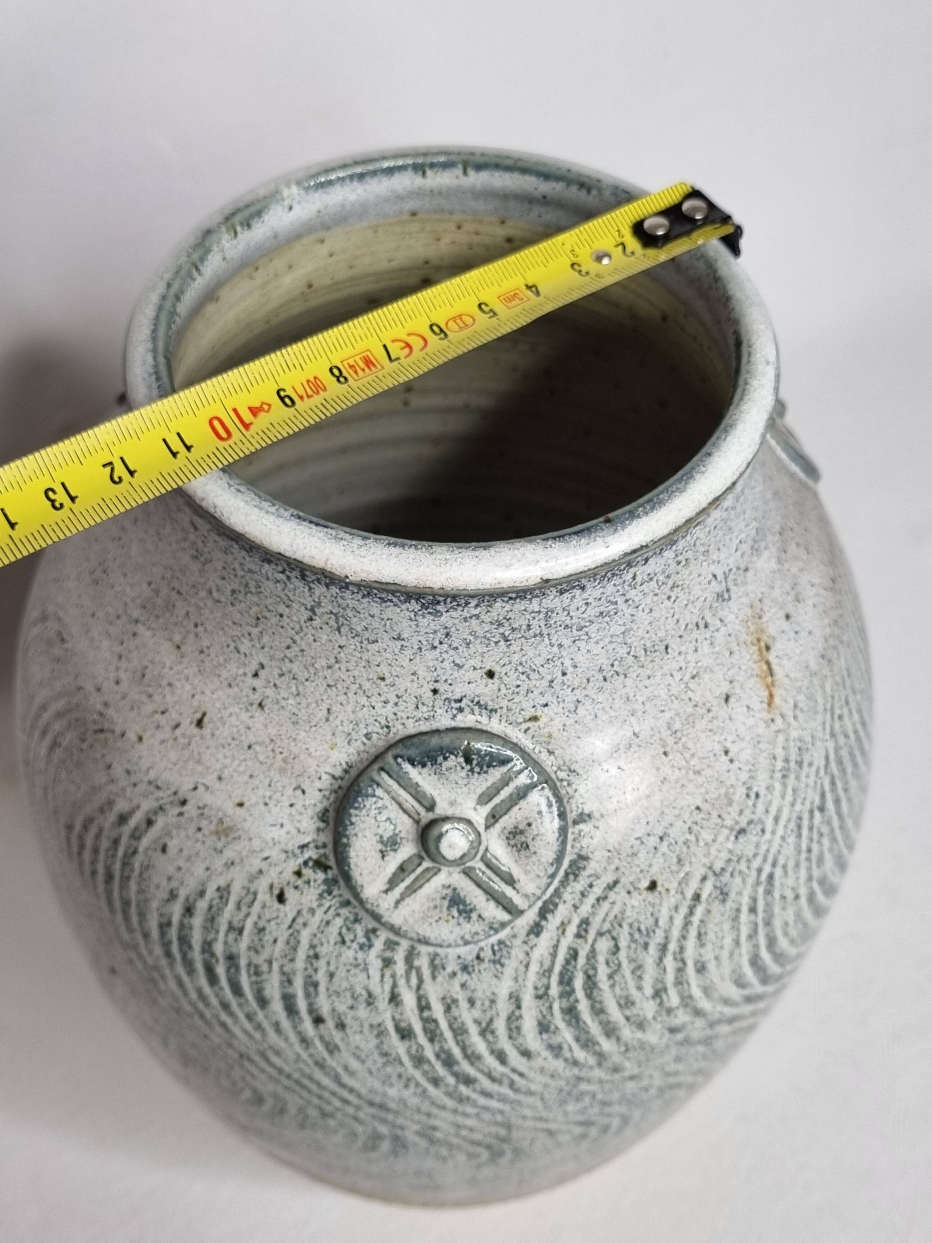 Stoneware vase signed by Sylvie Dufour, incised decoration and relief medallions, 28 cm.