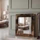 Vintage gold wall mirror with a smoked mirror border.