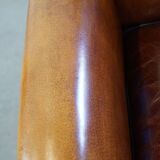 Sheep leather design armchair finished with decorative nails and black piping