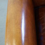 Sheep leather design armchair finished with decorative nails and black piping