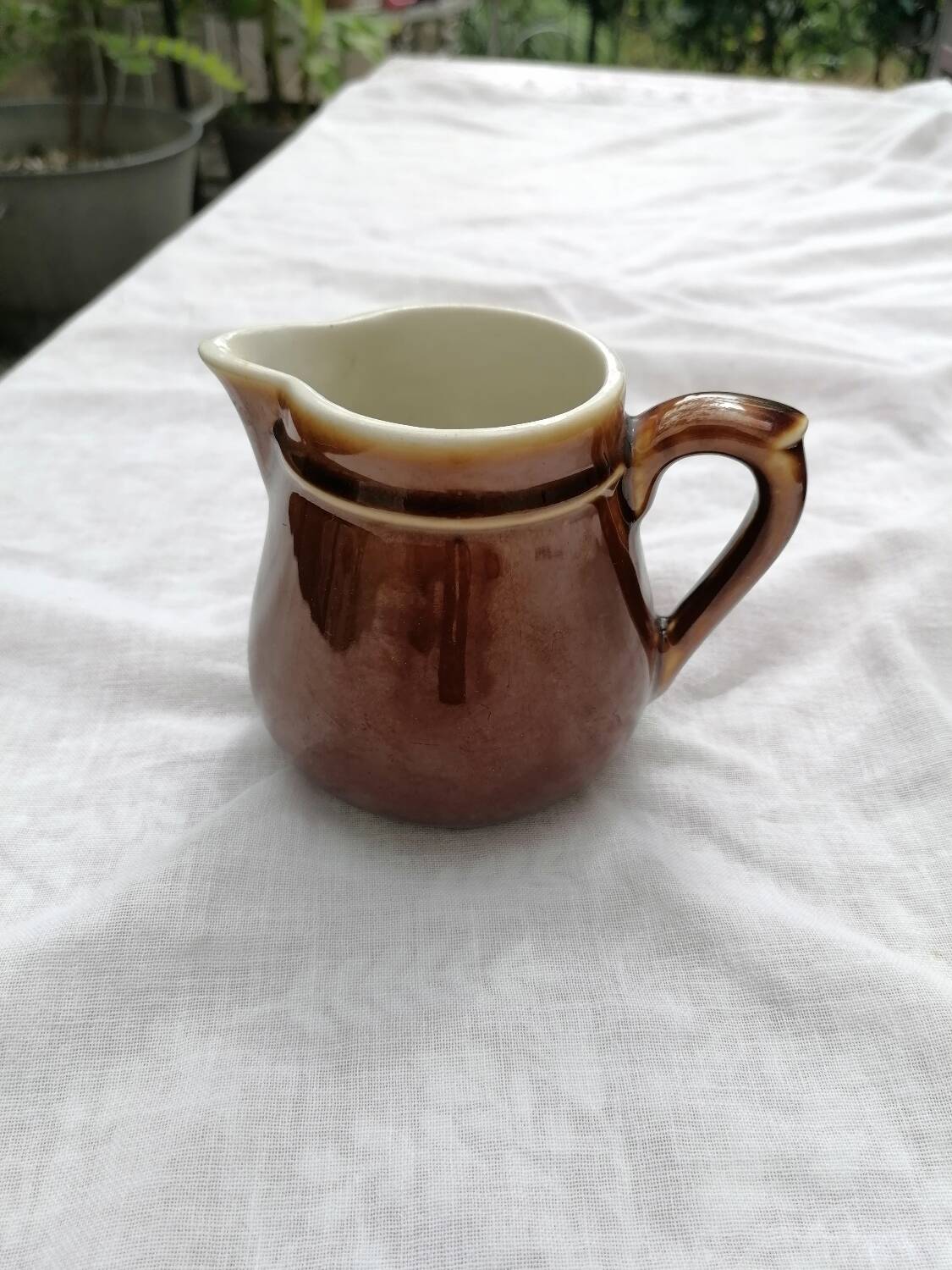 Brown ceramic teapot and milk jugs