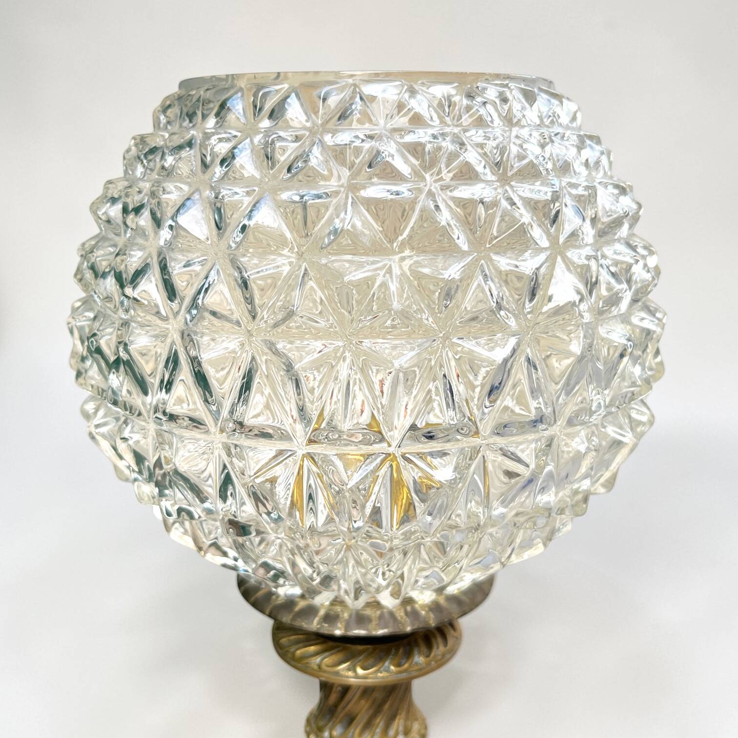 Antique brass foot lamp with glass globe and diamond point.