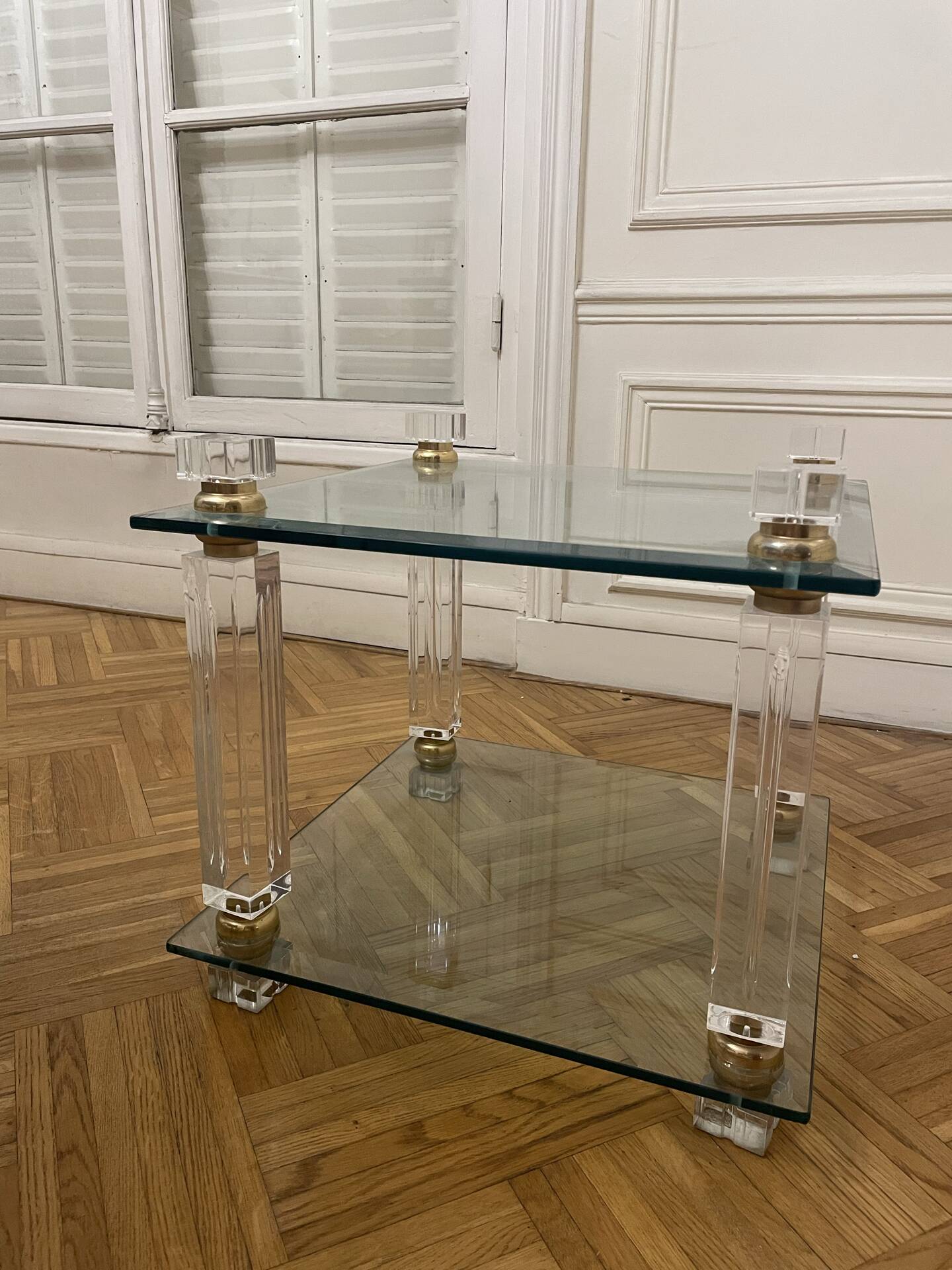 Glass side table with gold decorations.