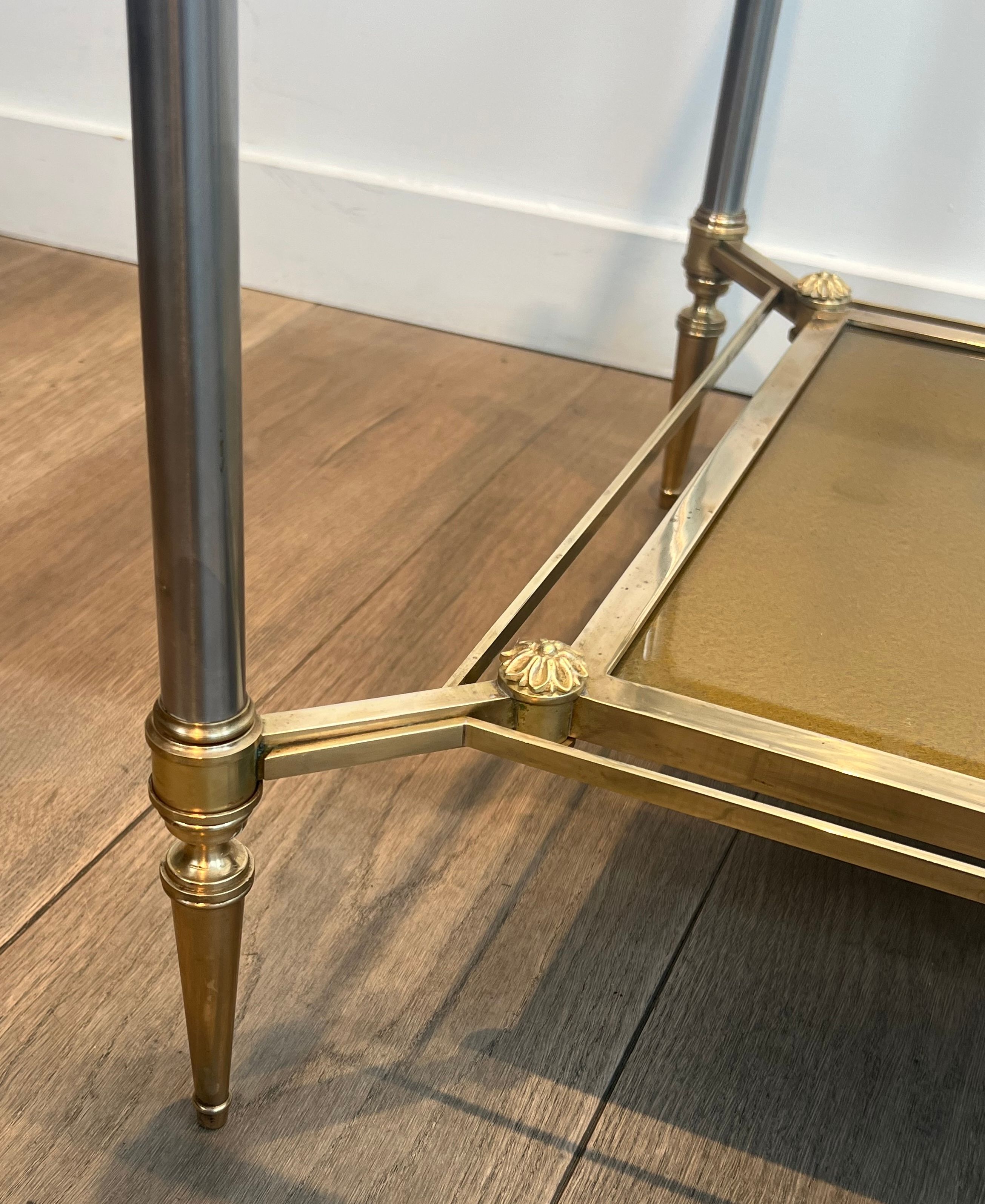Coffee table in brass, brushed steel, glass, and gilded eglomisé mirror from Maison Jansen.