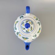 Blue teapot and yellow fruits