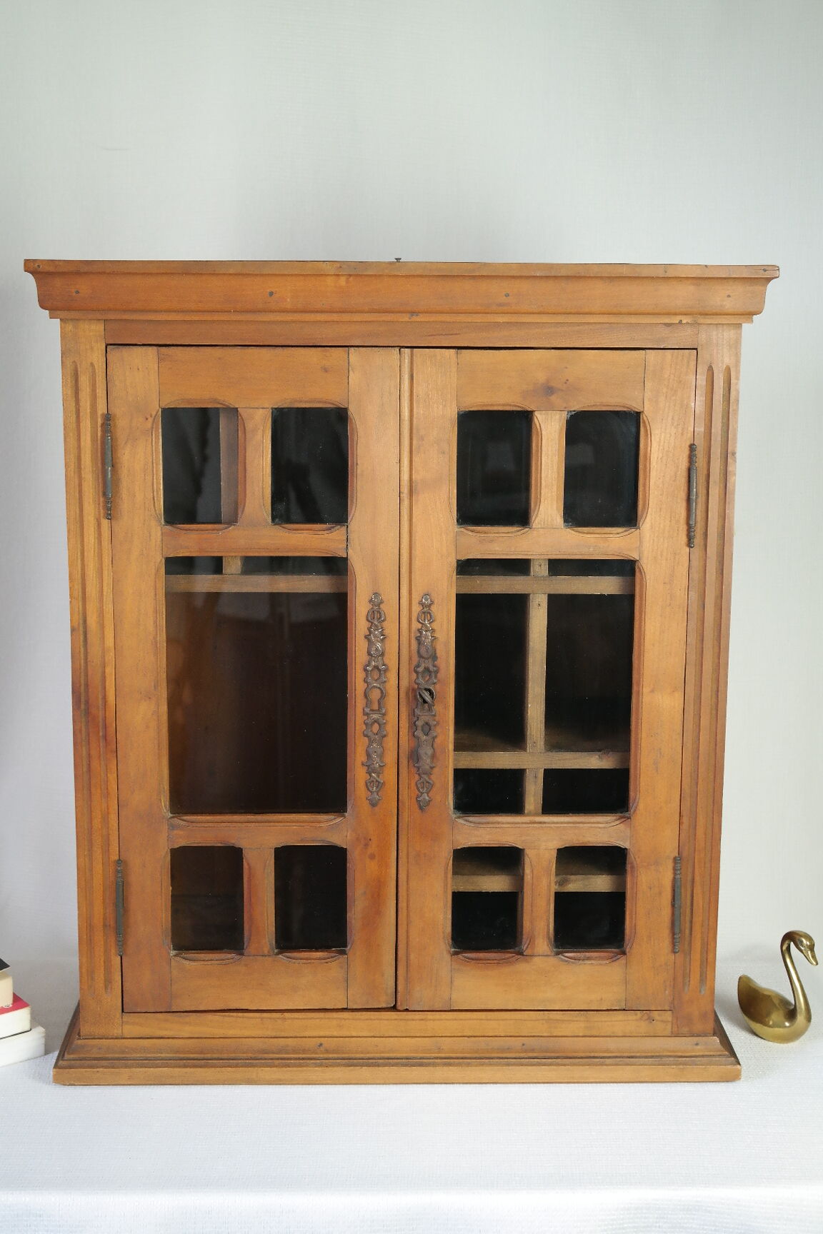 Antique walnut display cabinet from the 20th century.