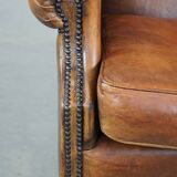 Large sheep leather wingback chair correctly finished with decorative nails
