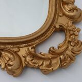 French Rococo or Baroque style facet-cut crest mirror in gilded carved wood