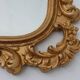 French Rococo or Baroque style facet-cut crest mirror in gilded carved wood