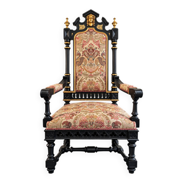 Historicist armchair in ebony wood and gold.