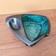 Ceramic ashtray with green and black glaze forming a pipe holder