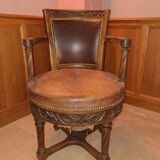 Antique swivel armchair in carved wood and patinated leather – neo-Renaissance style