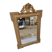 19th-century mirror in gilded wood and stucco.