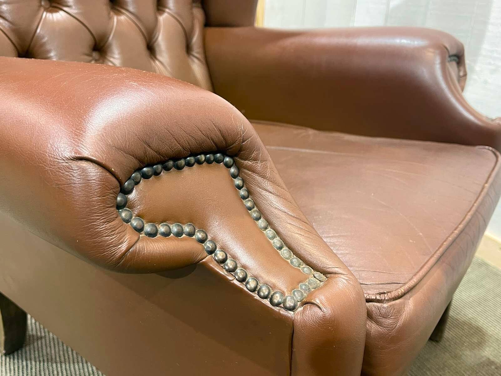 Pair of brown leather wingback Chesterfield armchairs from the 1970s.