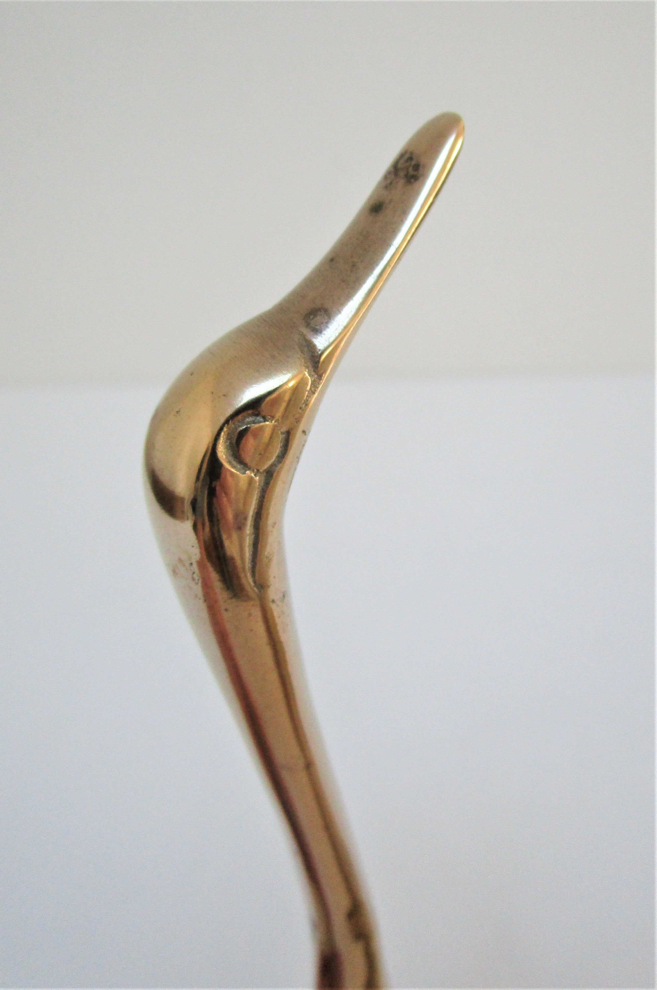 Pair of stylized birds in solid brass