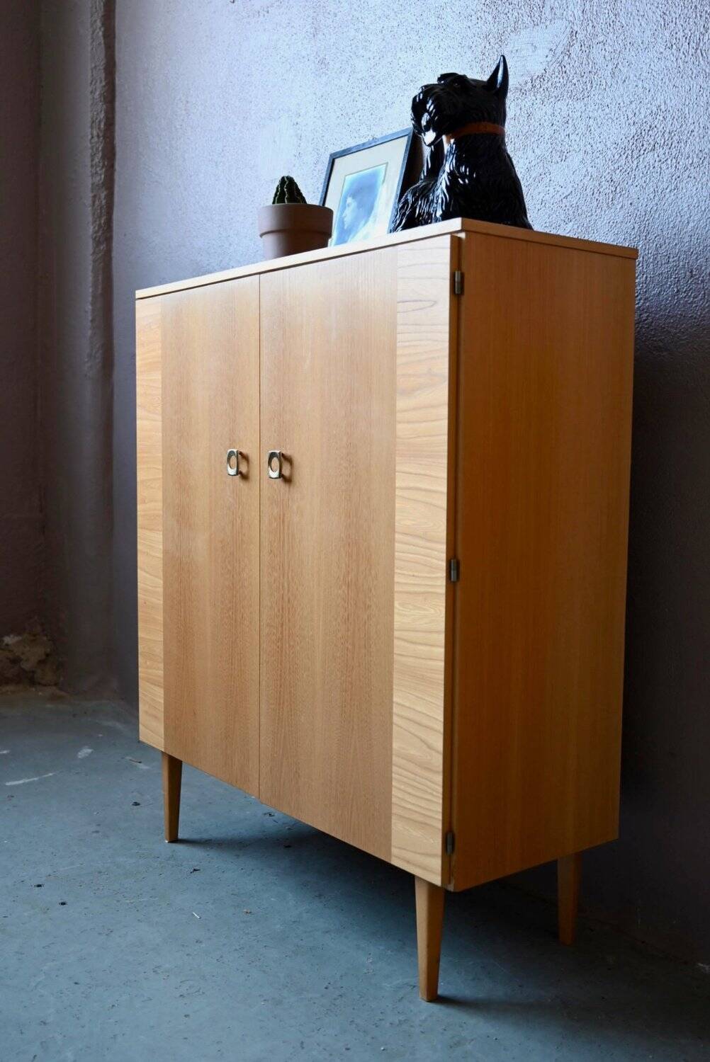 Vintage 1960s shoe cabinet in light wood and chrome metal.