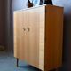 Vintage 1960s shoe cabinet in light wood and chrome metal.