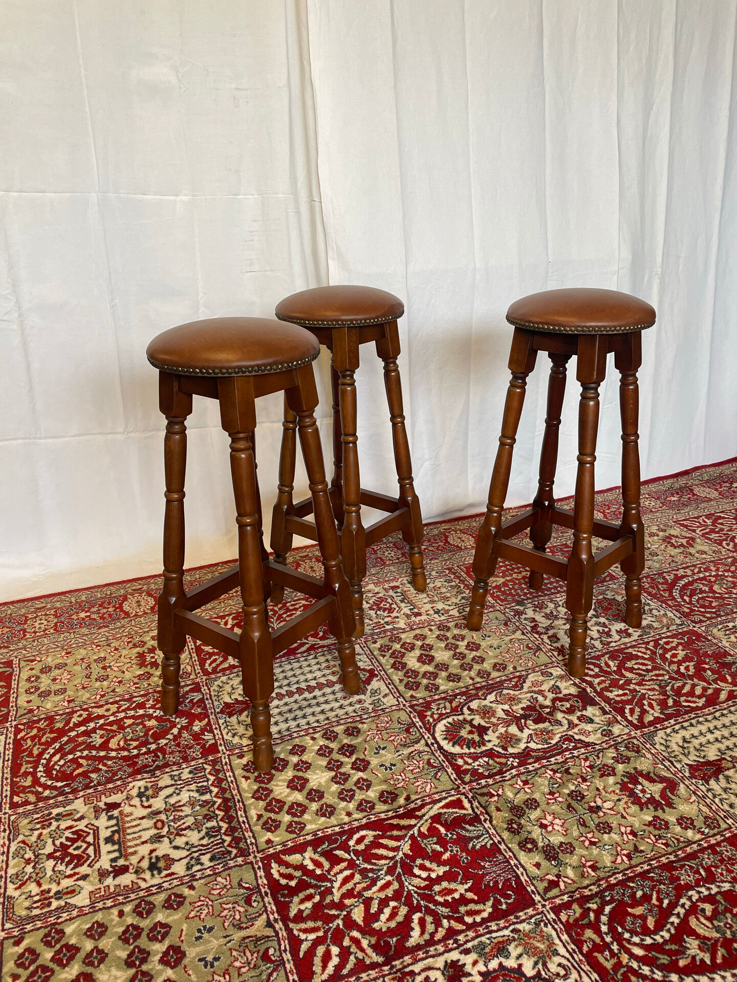 Set of 3 antique wooden and leather bar stools.