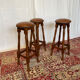 Set of 3 antique wooden and leather bar stools.