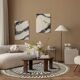 Round jute rug with white relief patterns.
