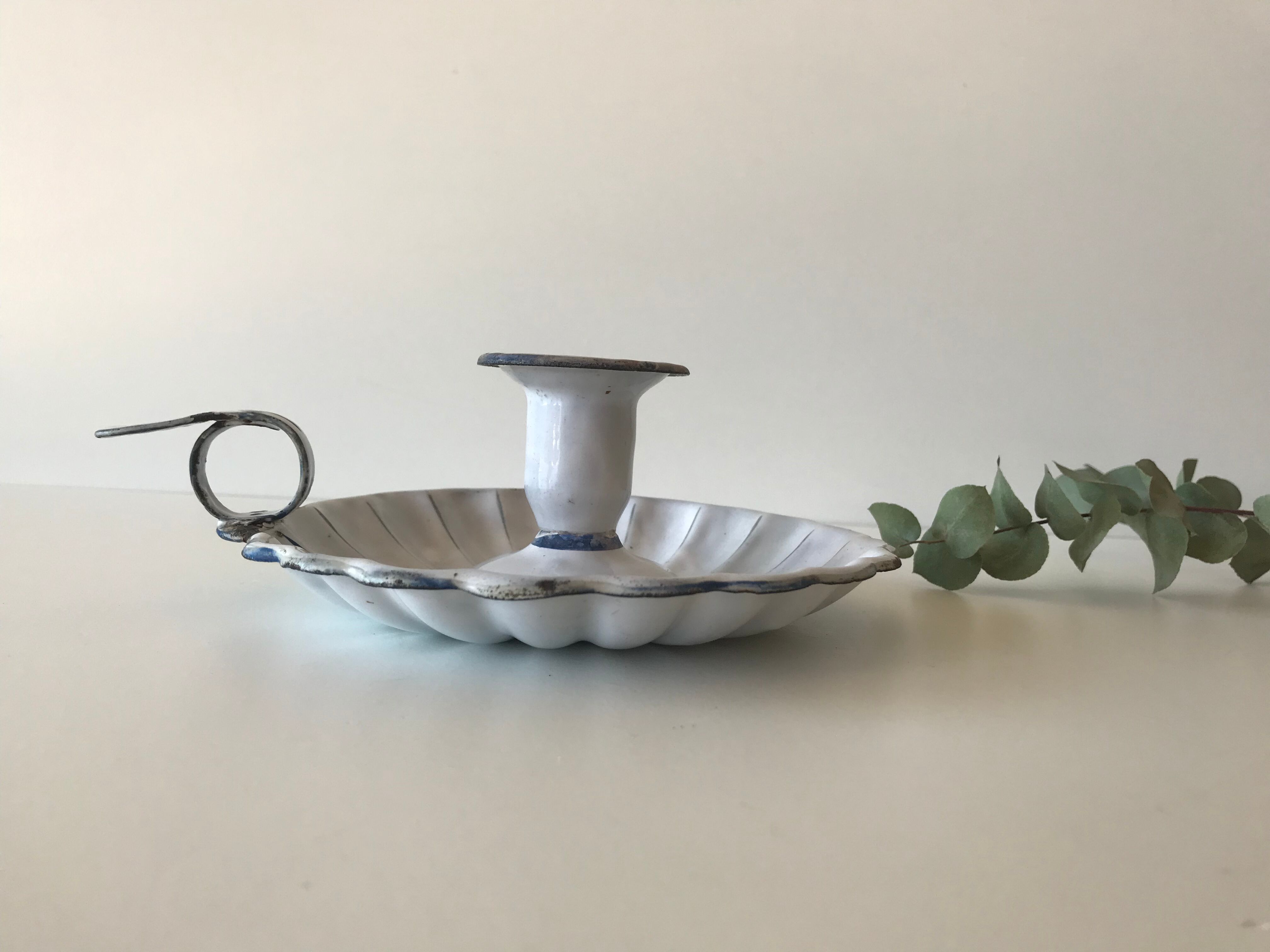 Candlestick in white enameled metal