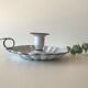 Candlestick in white enameled metal
