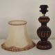 Mid-century French table lamp made of turned carved wood with a fringed shade.
