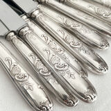 12 antique silver-plated knives with acanthus shell decoration and stainless steel blades.