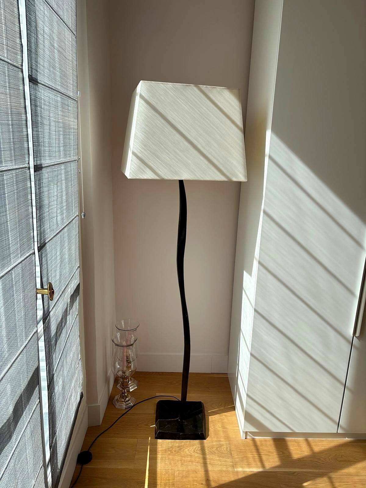 Pair of hammered black metal floor lamps with white shades.