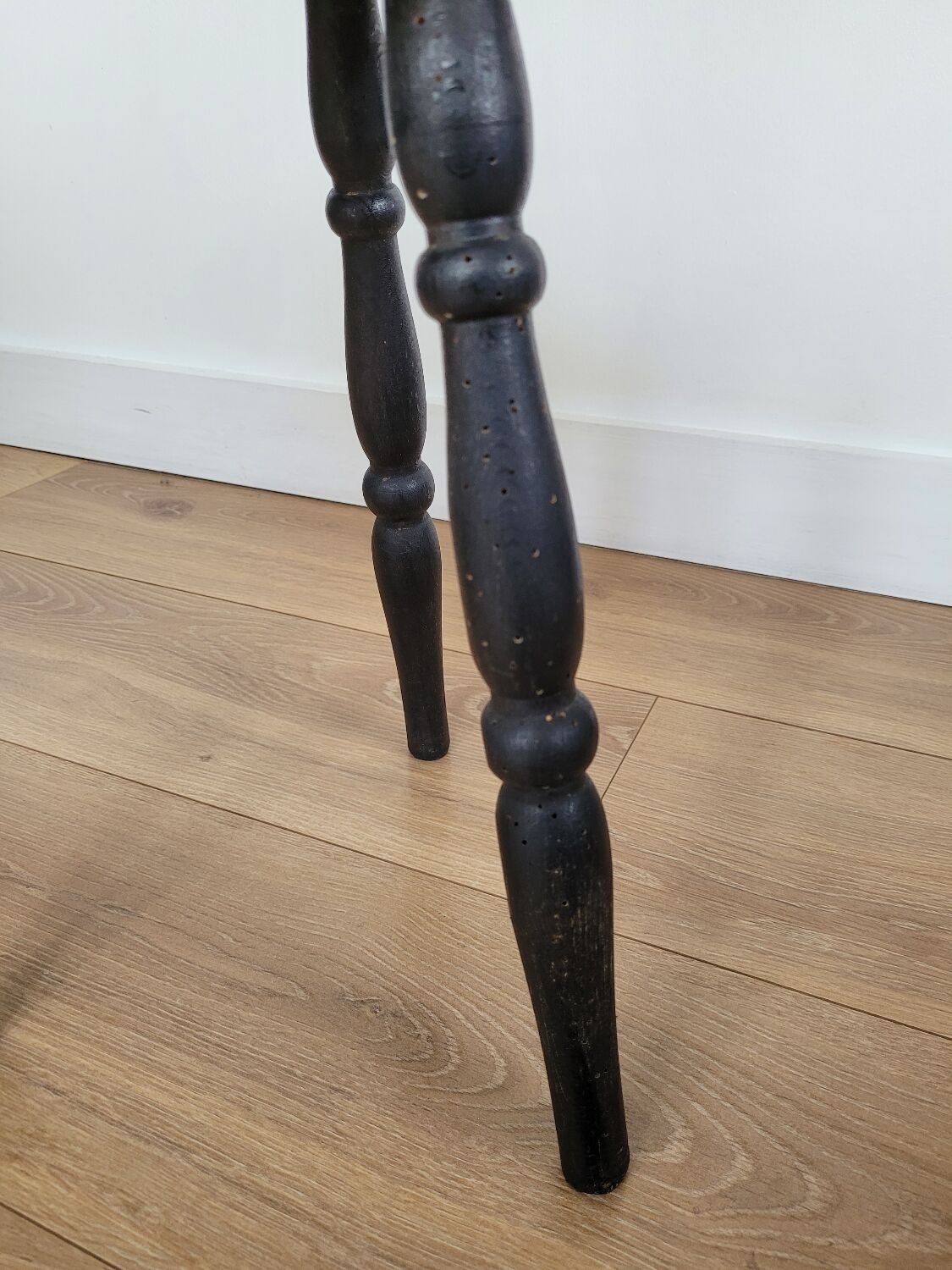Black wooden tripod stool