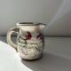 Floral decorated pitcher signed