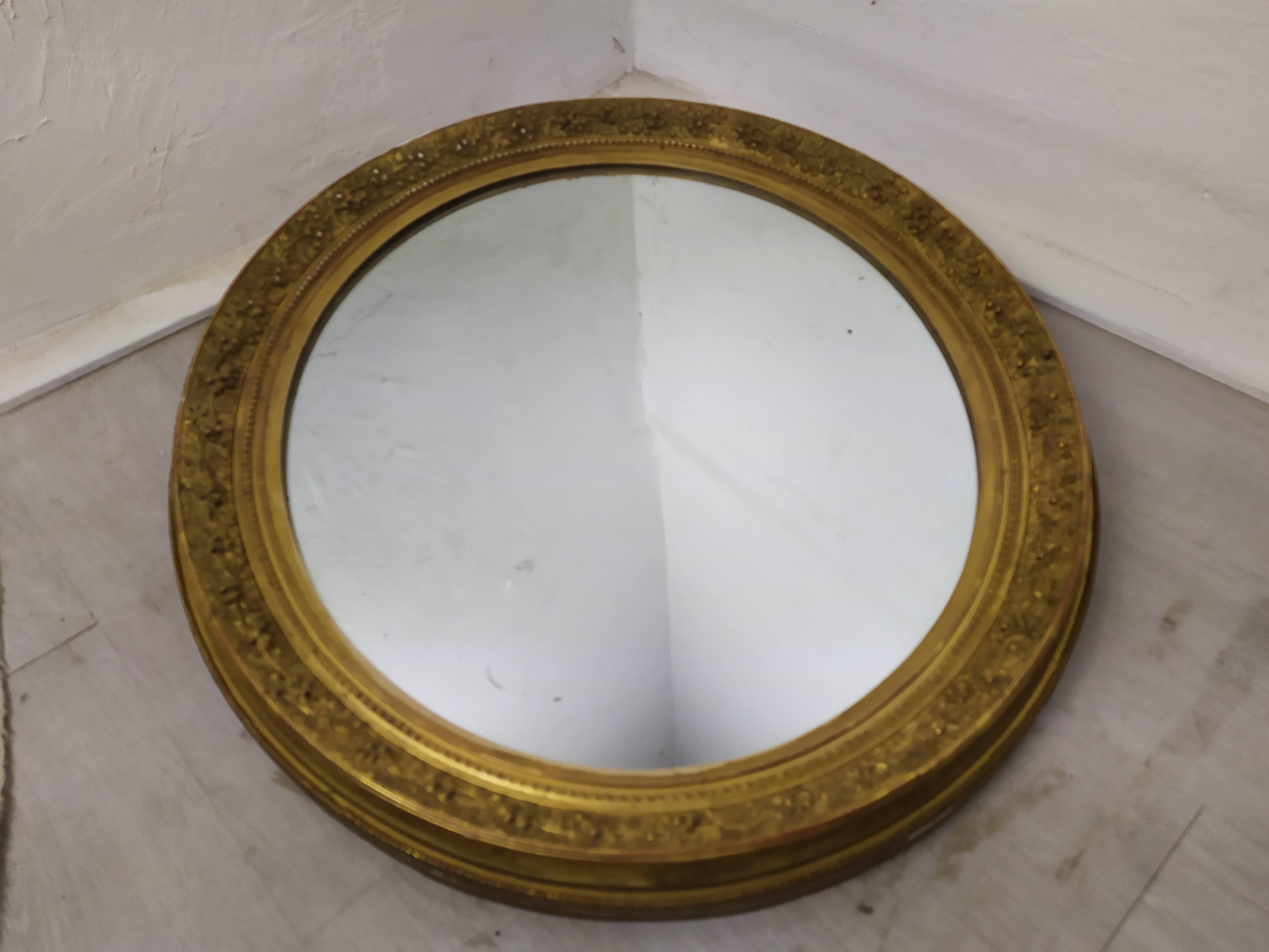 Golden oval mirror