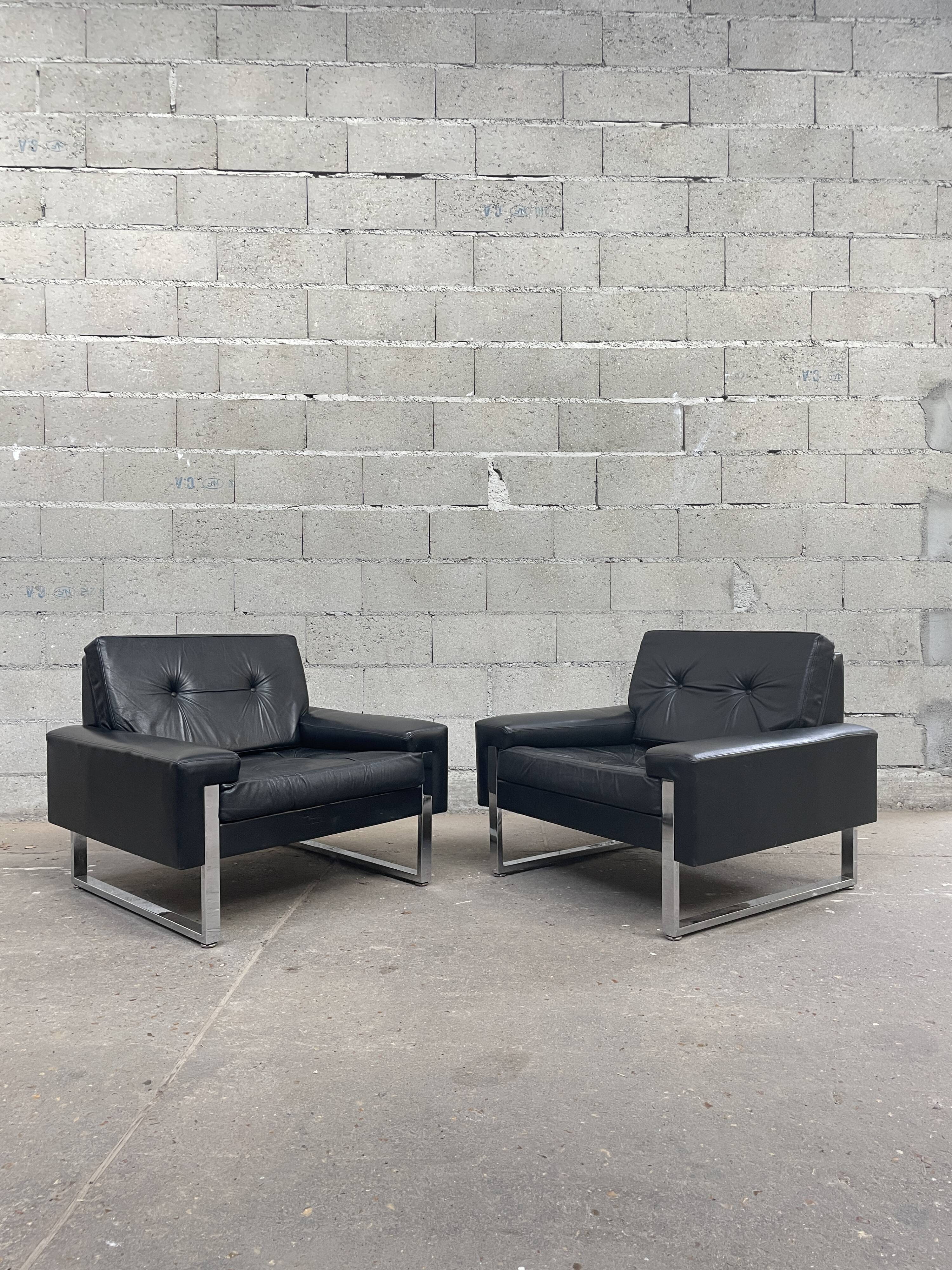 Pair of black leather armchairs