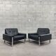 Pair of black leather armchairs