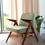 Vintage armchair in mint green wool, mid-century modern design.