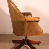 Office chair known as a presidential chair in mahogany and cognac leather.
